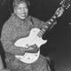 Sister Rosetta Tharpe smiling with her guitar